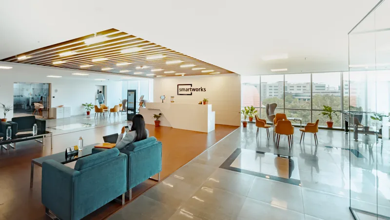 People meeting in a staffed office reception area